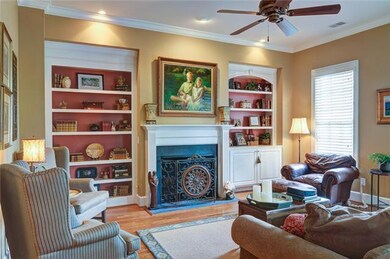 Great Room features beautiful HARDWOODS, traditional fireplace with substantial BUILT-IN BOOKCASES on either side.