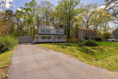 View of front of property featuring a detached gar