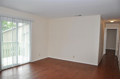 Unfurnished room with dark wood-style flooring an