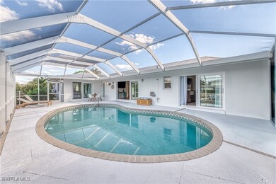 Pool featuring glass enclosure and a patio