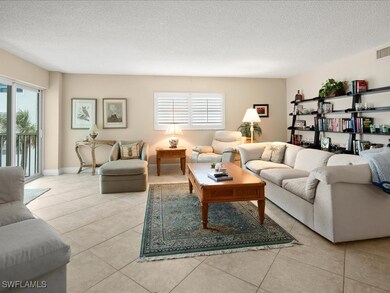 Living room featuring a textured ceiling and tile patterned flooring