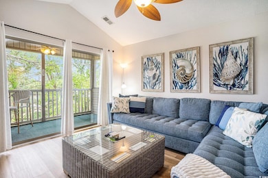 Living room with wood finished floors, lofted ceil