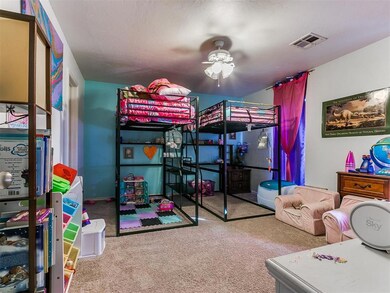 Bedroom featuring ceiling fan, carpet, and a textu