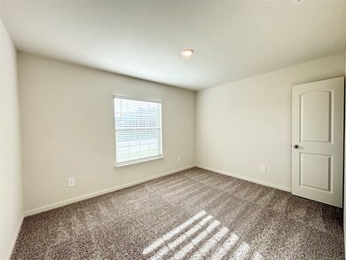 Empty room featuring carpet floors and baseboards