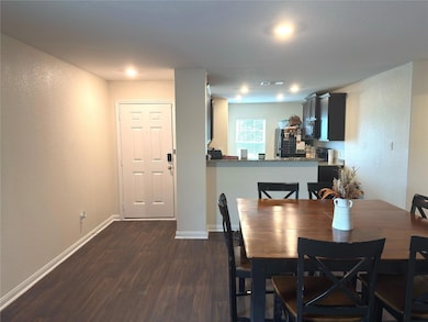 Dining space featuring dark wood-type flooring, b