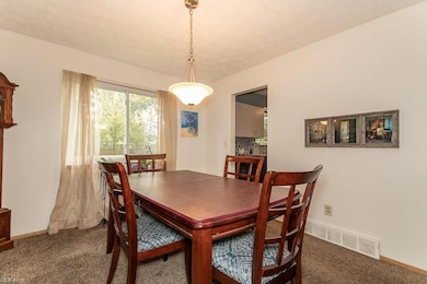 Dining space featuring dark colored carpet