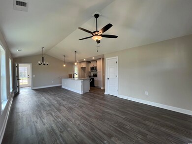 Unfurnished living room with lofted ceiling, dark 