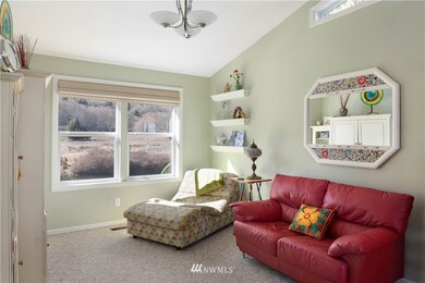 The formal dining room is currently used as a TV nook. Enjoy the views across the lagoon to the conservation area beyond.