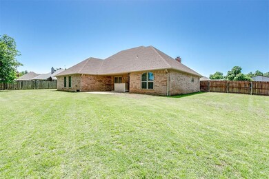 Rear view of house featuring a lawn
