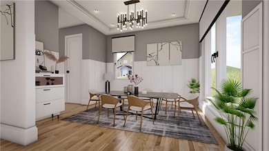 Dining room featuring light wood-type flooring, a tray ceiling, a chandelier, and recessed lighting