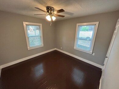 Spare room with ceiling fan, a textured ceiling, a