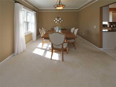 Dining Room. Impressive Dining room features gorgeous crown molding and beautiful stained glass pendant lighting!