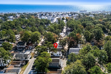 Aerial overview of property's location with a nearby body of water and nearby suburban area
