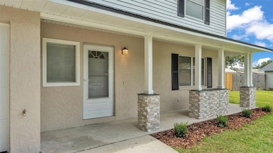 Welcoming Front porch !! Stonework shows off the pillars!