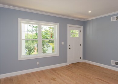 Living Room with hardwood floors, crown molding an