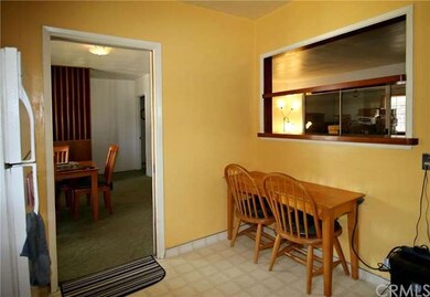Small dining area in kitchen with pass-thru.