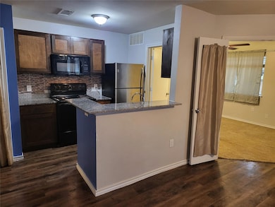 Kitchen featuring kitchen peninsula, backsplash, b