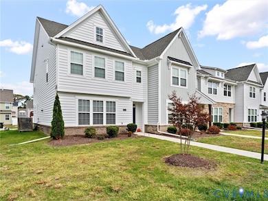 View of front of home with a front lawn, board and batten siding, brick siding, and roof with shingles