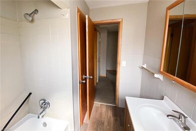 Bathroom featuring tiled shower / bath combo, vani