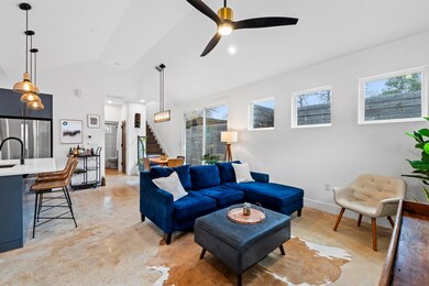 Living area featuring baseboards, finished concre