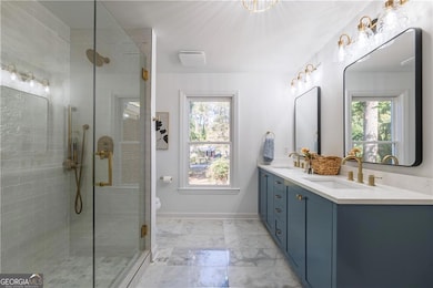 The luxurious primary bathroom showcases ocean whi