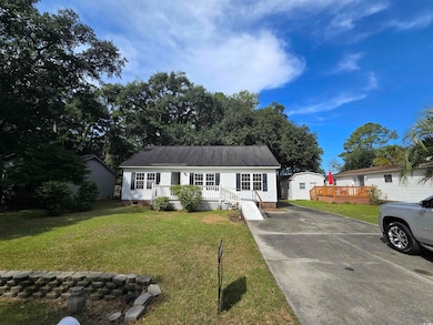 Ranch-style home featuring a wooden deck, a front 