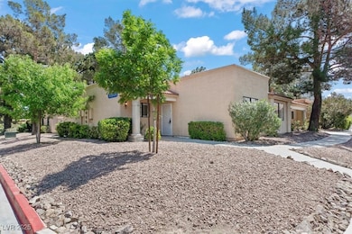 View of front of house with a tile roof and stucco