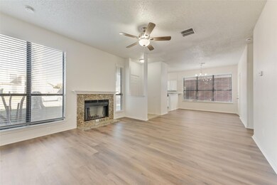 Unfurnished living room featuring a fireplace, lig