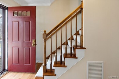Foyer with hardwood floor and crown molding!