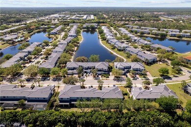 Birds eye view of property with a water view and a