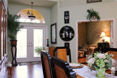 Beautiful ornate glass pattern on the front door is elegant. To the right is the den with glass french doors. A private oasis with hand painted walls & ceilings!