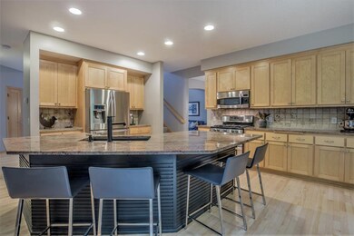 Kitchen with tile backsplash, center island with s