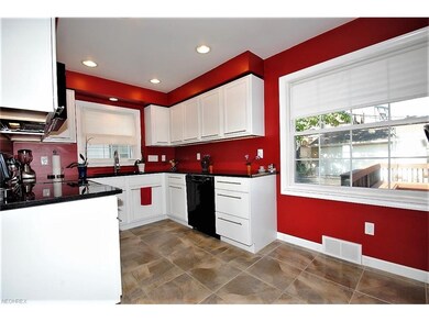 BEAUTIFULLY UPDATED KITCHEN HAS WHITE CABINETRY AN