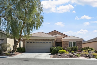 View of front facade with a garage, driveway, ston