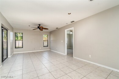 Empty room with light tile patterned floors, visib