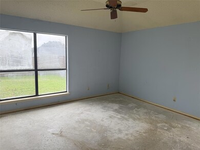 Spare room featuring ceiling fan and a textured ce