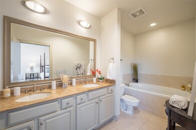 The primary suite's ensuite bath serves as a spa-l