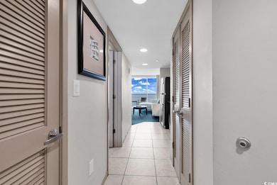 Hall featuring recessed lighting and light tile patterned floors