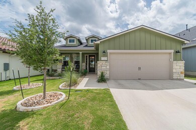 Craftsman house with stone siding, an attached ga