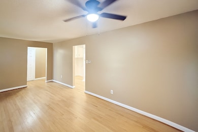 Spare room with light wood-style flooring, a textured ceiling, and ceiling fan