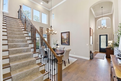Grand staircase with elegant railings leads to the upper floor.