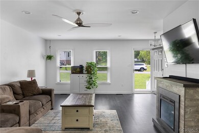 Living room with dark wood-type flooring and ceili
