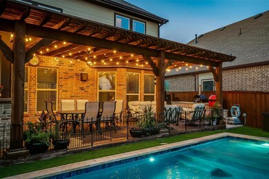 Pool at dusk with a pergola and a patio