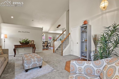 Carpeted living area with stairway, a high ceiling, recessed lighting, and baseboards