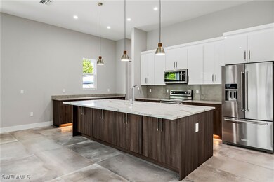 Kitchen featuring light quartz countertops, stainl