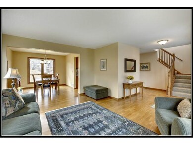 Open floor plan with hardwood floors through foyer