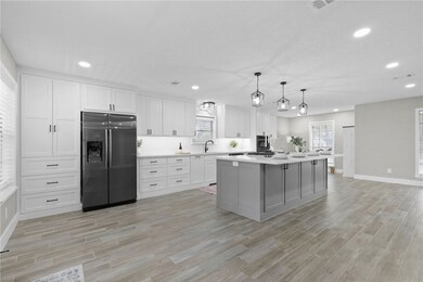 Kitchen featuring light countertops, white cabinet