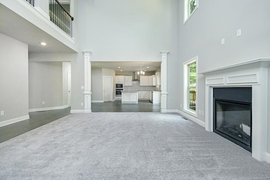 Unfurnished living room with a glass covered firep
