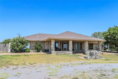 View of front of home with a front yard and a porc