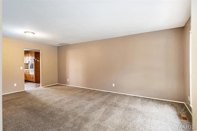 Unfurnished room featuring carpet and baseboards